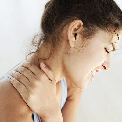 Young Woman Holding Her Neck in Pain