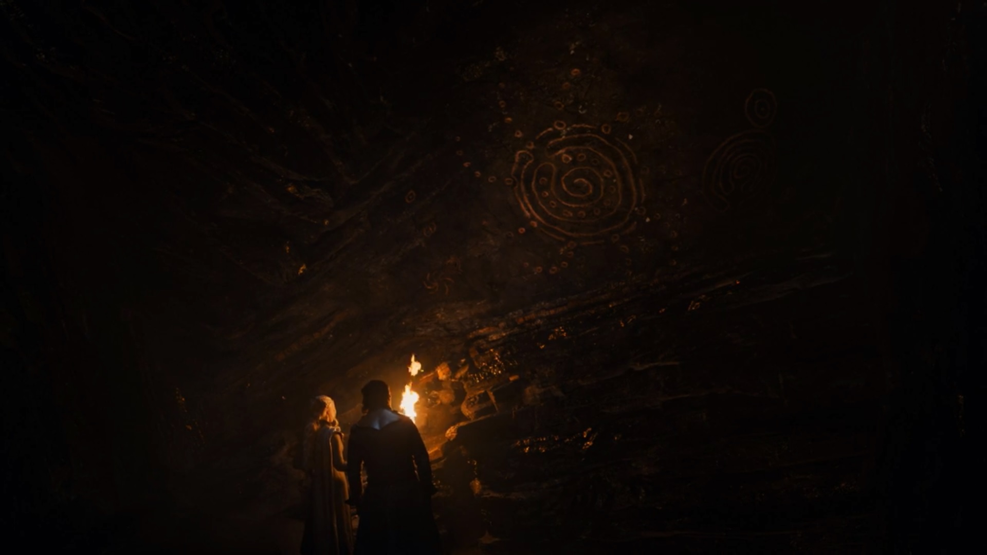 Jon Snow and Daenerys Targaryen in the caves under Dragonstone with the drawings of the Children of the Forest